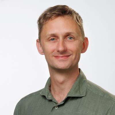 Portrait of me in a green linen shirt. I am a white male with blonde hair and green (sometimes blue) eyes.